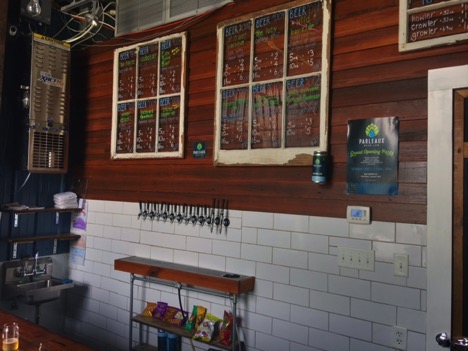 (100 year old reclaimed windows that have survived Hurricanes Katrina, Betsy, & Camille, originally from the owners home, provide the perfect backdrop for the Craft Beer menu)